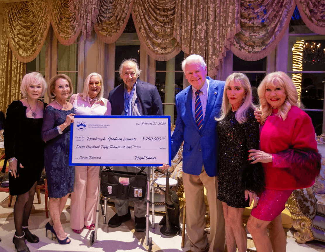 Members of Royal Dames holding a check