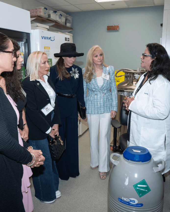 Members of Royal Dames listening to a scientist