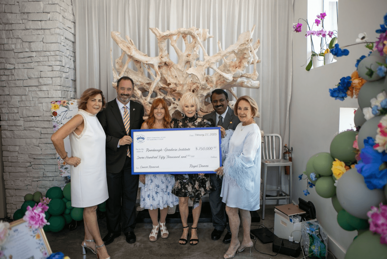 Members of Royal Dames holding a check